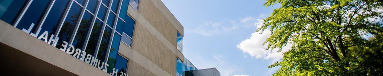 Sun shining over the James H. Zumberge Hall entrance, the building in which Human Resources is located